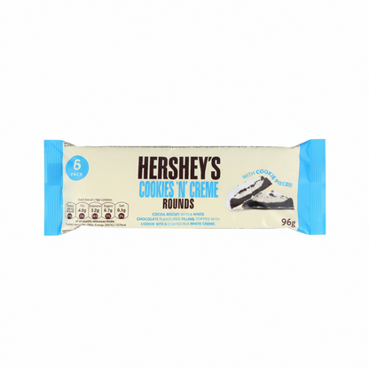 Confezione di biscotti HERSHEY’S COOKIES ’N CREME ROUNDS con doppio strato di crema e ricoperti di cioccolato bianco e pezzetti di biscotto. La scatola mostra i biscotti rotondi in primo piano. Biscotti ripieni americani, formato 96 grammi.